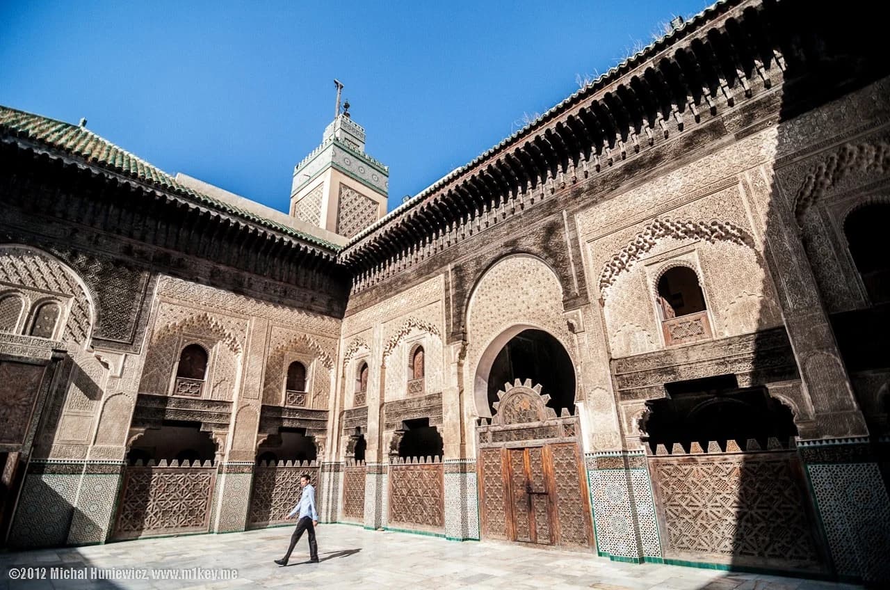 Carved arcades and tilework surrounding a courtyard in Fes