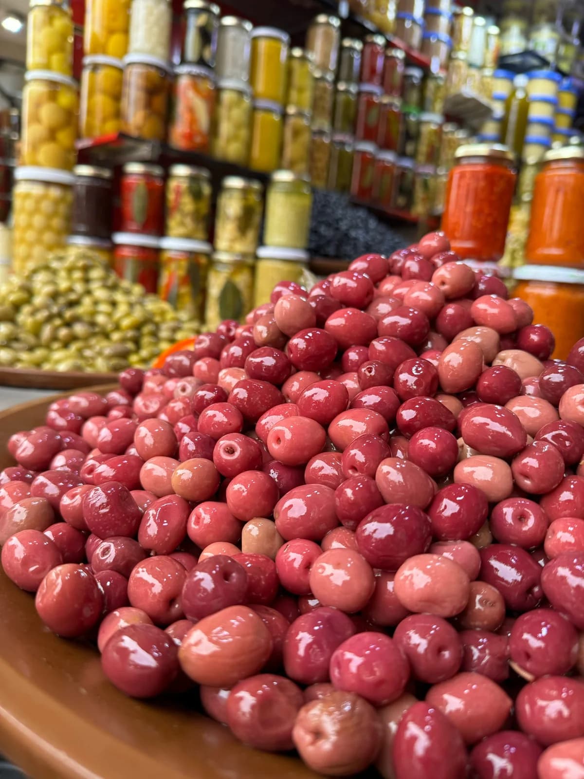 Olives and preserved ingredients displayed at a Marrakech market stall