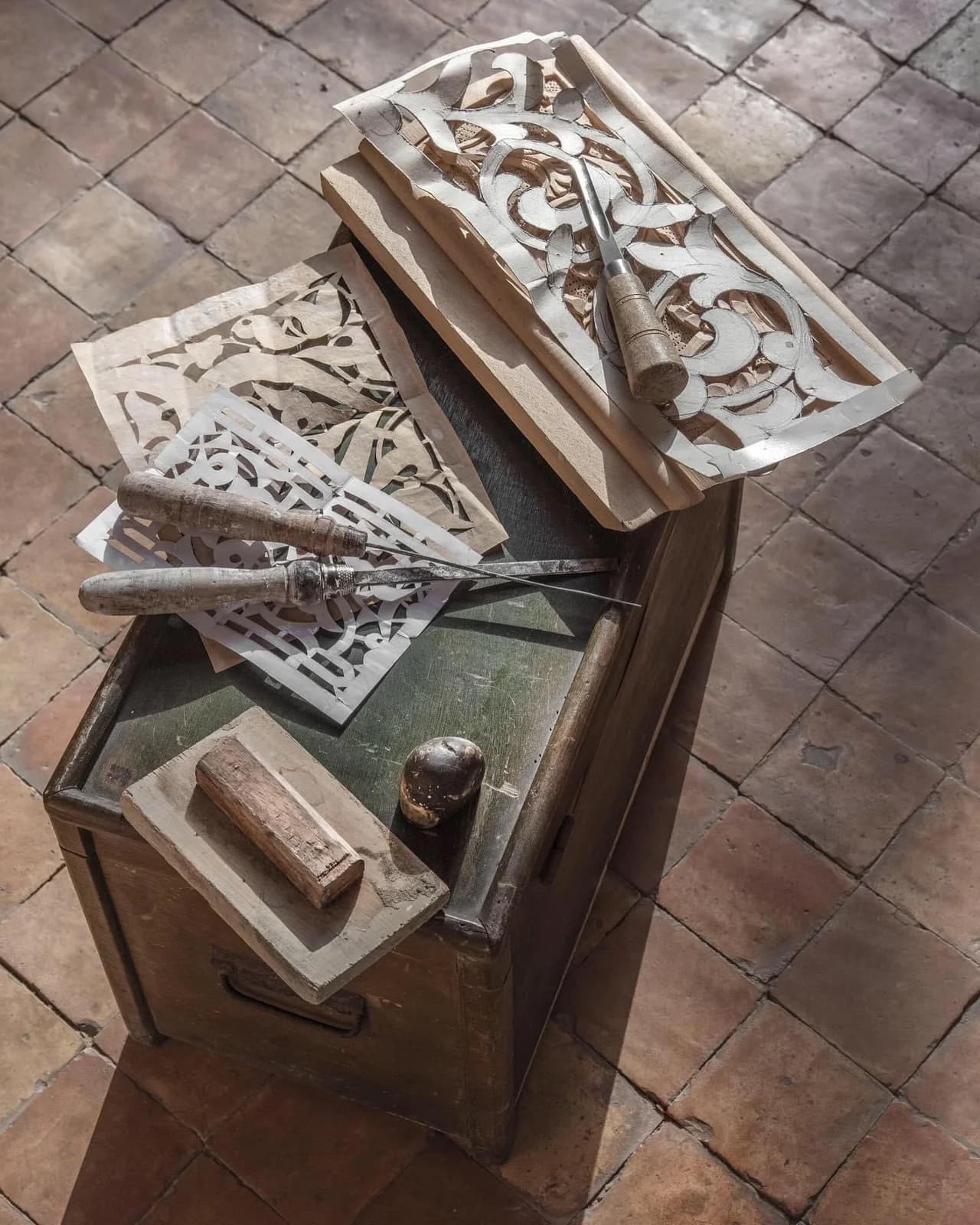 Carved decorative panels, pattern templates and hand tools