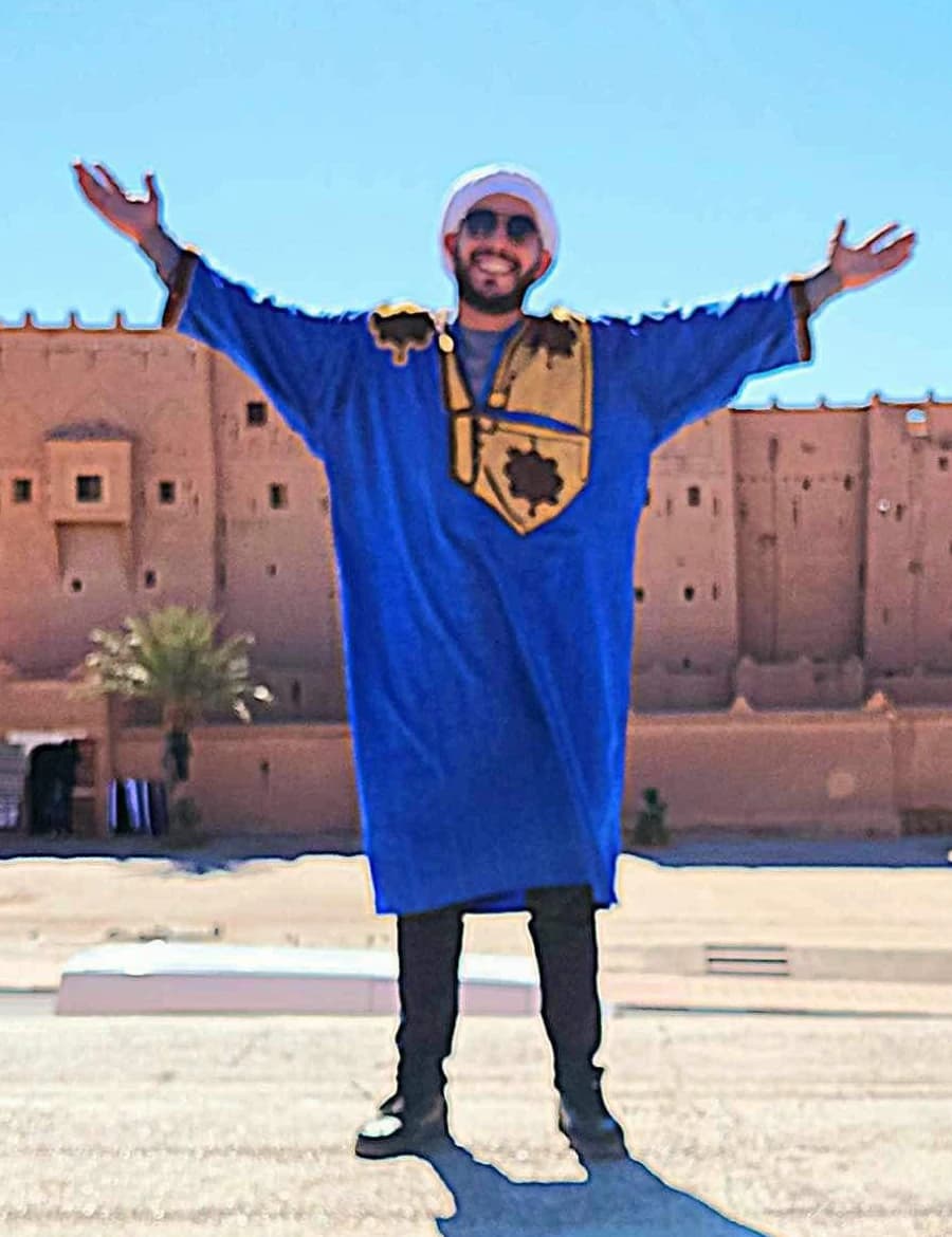 Abdel, founder of Morocco Travelogue, in front of a Moroccan kasbah