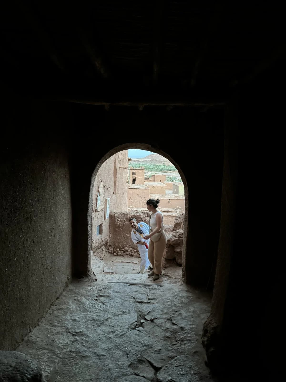 An earthen passage framing a doorway at Ait Ben Haddou