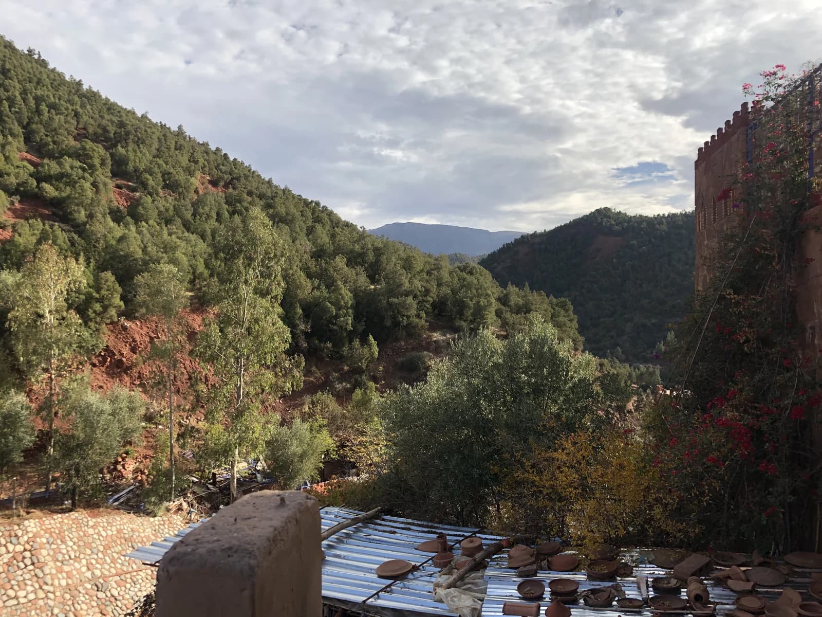 A table set for a meal beneath trees in an Atlas mountain garden