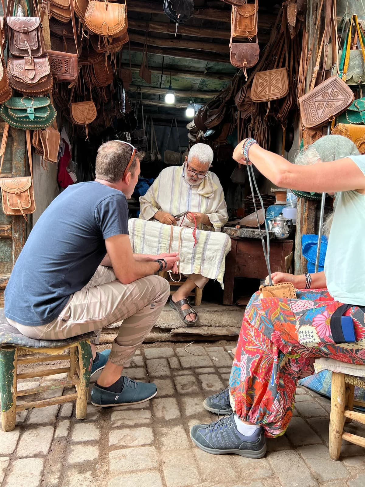 Visitors talking with a craftsperson in a Marrakech shop