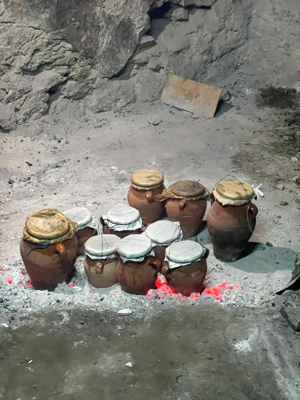Earthenware tangia pots warming over embers