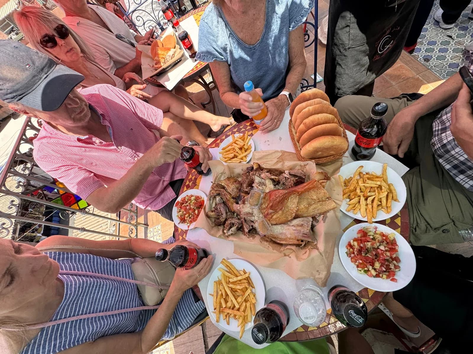 Travellers sharing bread, salads and Moroccan dishes around a table